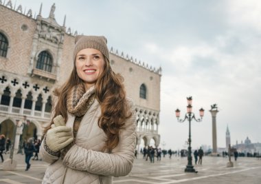 Woman tourist standing on St. Mark's Square near Dogi Palace