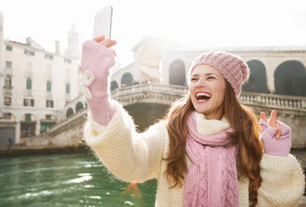 Woman tourist showing victory while taking selfie in Venice — Stockfoto