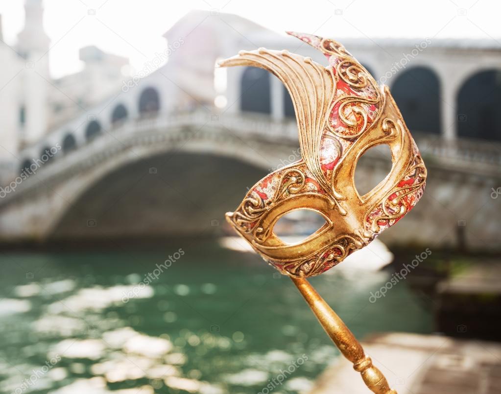 Closeup on woman hand holding Venice Mask near Rialto Bridge