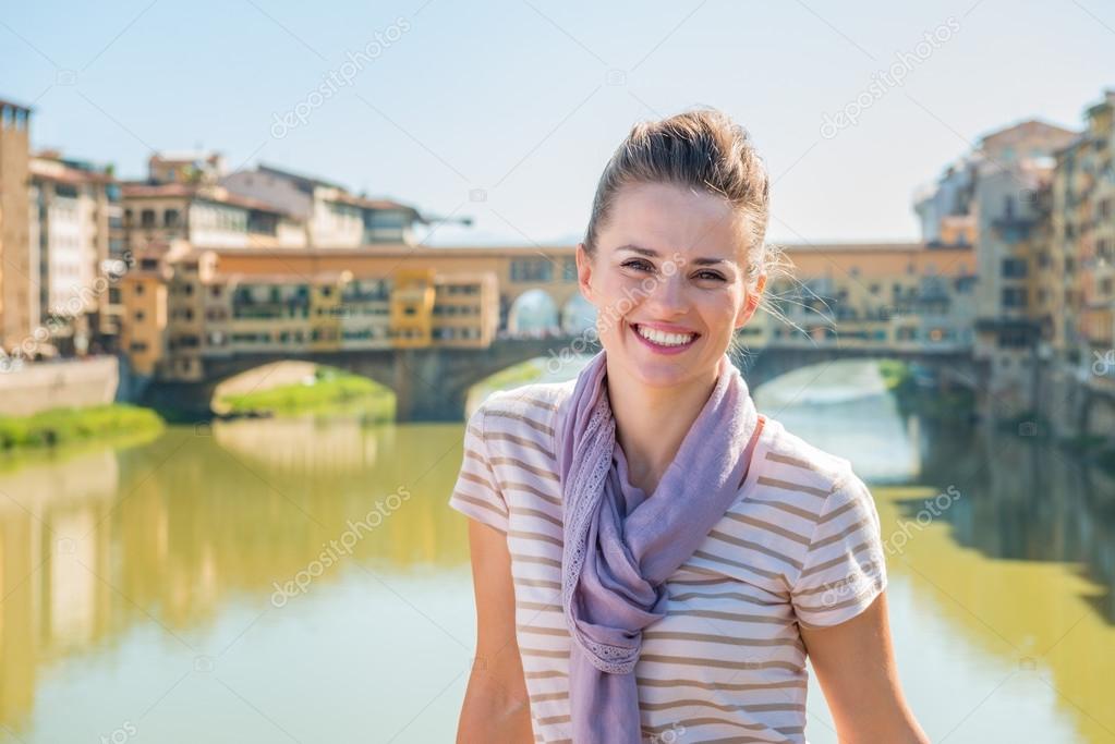 Happy tourist standing on the bridge overlooking Ponte Vecchio
