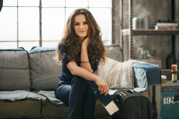 Woman with luggage in loft apartment waiting for departure