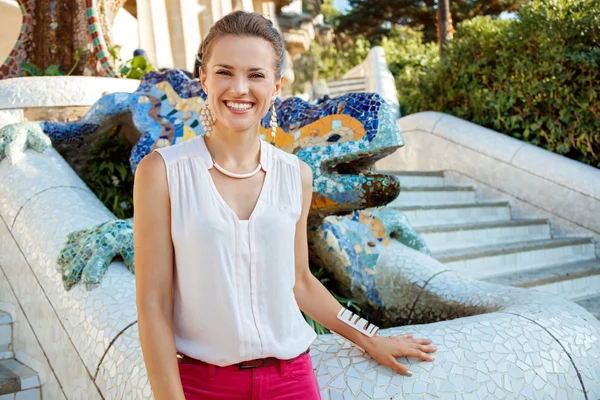 Porträt einer glücklichen Frau in der Nähe von Mosaikdrachen im Park Güell, Spanien — Stockfoto