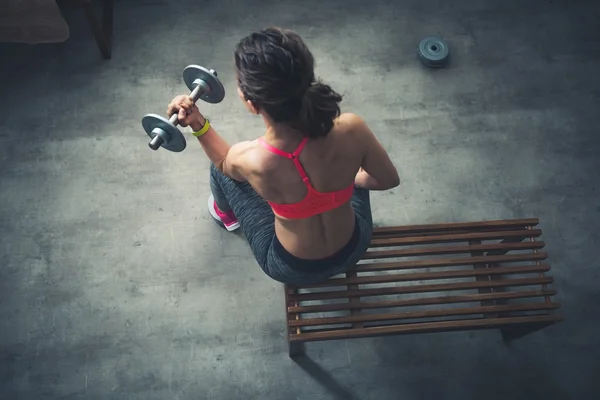 Horní pohled na fitness žena zvedání činka v tělocvičně loftovém — Stock fotografie