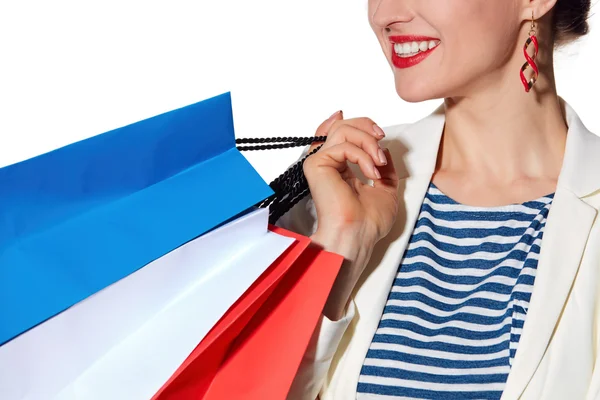 Primeros planos de mujer sonriente con bandera francesa colores bolsas de compras — Foto de Stock