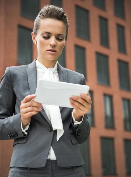 Moderne zakenvrouw tegen kantoorgebouw met behulp van tablet Pc — Stockfoto