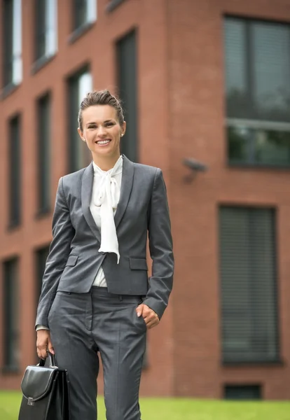 Portrait of business woman with briefcase near office building — Stock Photo, Image