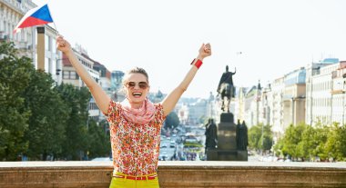 Woman with Czech flag rejoicing near National Museum in Prague