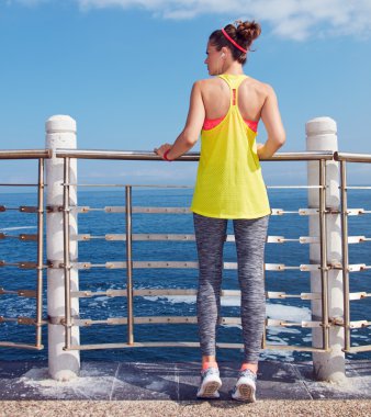 young athlete looking into distance at embankment