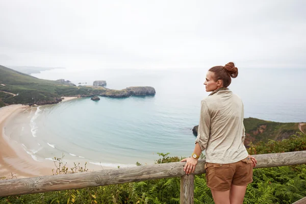 Visto de trás mulher caminhante olhando para a paisagem vista do oceano . — Fotografia de Stock