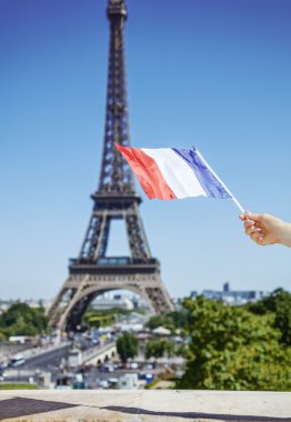 Paris'te Eyfel Kulesi önünde bayrak gösterilen yandan portre
