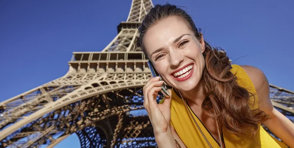 smiling young woman talking on cell phone in Paris, France