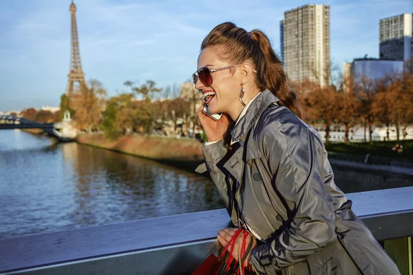 Woman looking into distance and speaking on cell phone, Paris