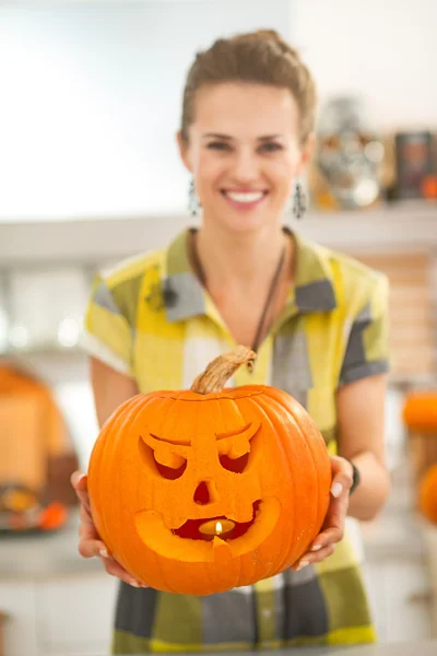 Close-up op huisvrouw toont pompoen Jack-O-lantaarn met kaars — Stockfoto