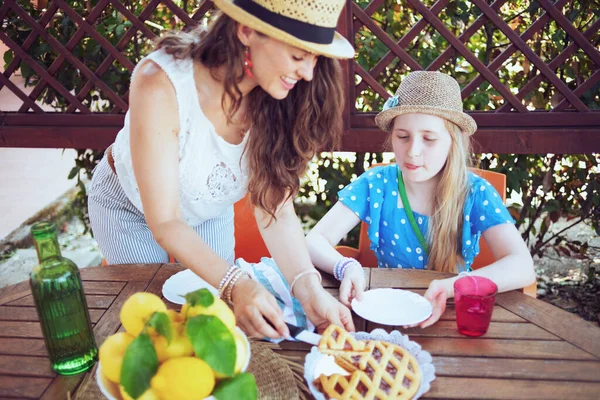 Sonriente Elegante Madre Hija Con Crostata Botella Verde Agua Plato — Foto de Stock