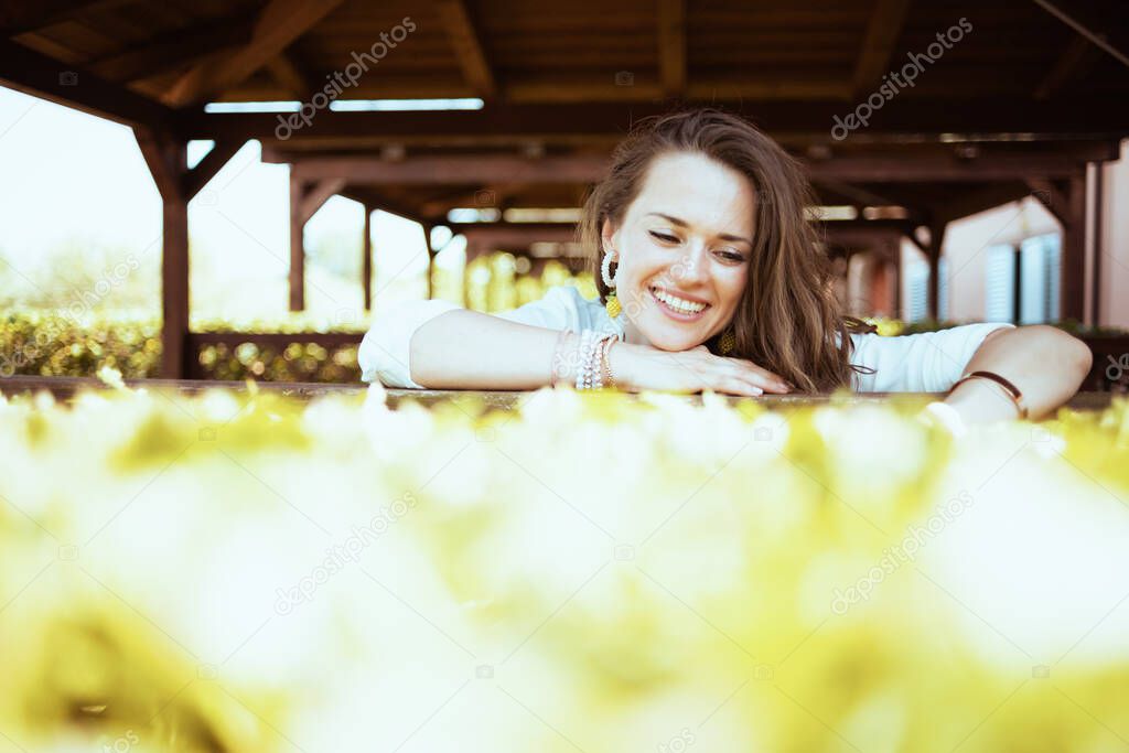 smiling trendy female in white shirt on the farm.
