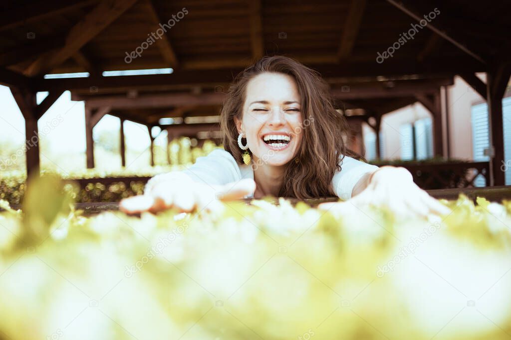 smiling elegant middle aged woman in white shirt on the farm.