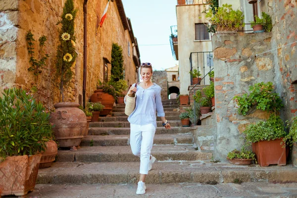 Travel in Italy. happy young traveller woman in Tuscany, Italy exploring attractions in Pienza.