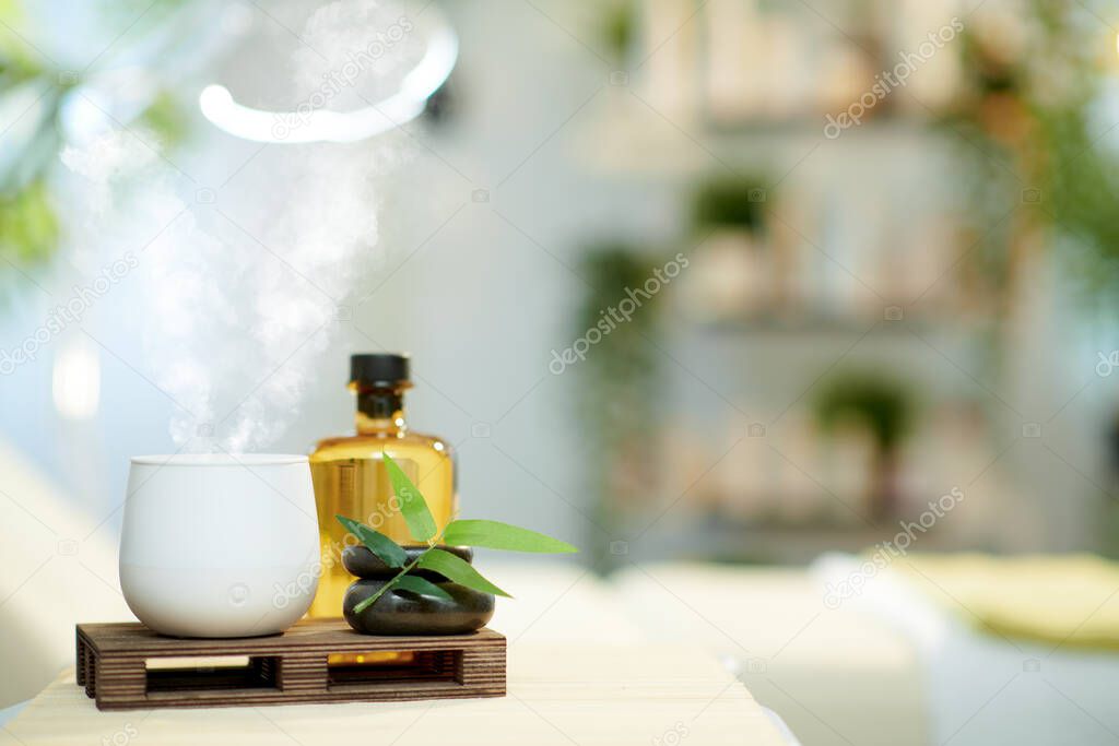 aroma lamp and essential oils in modern beauty salon.
