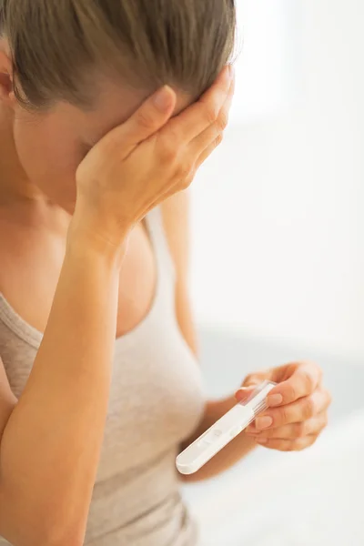 Frustrated young woman with pregnancy test — Stock Photo, Image