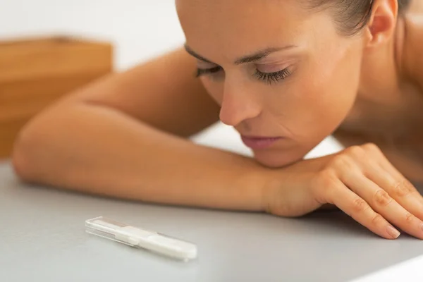 Portrait of young woman looking on pregnancy test — Stock Photo, Image