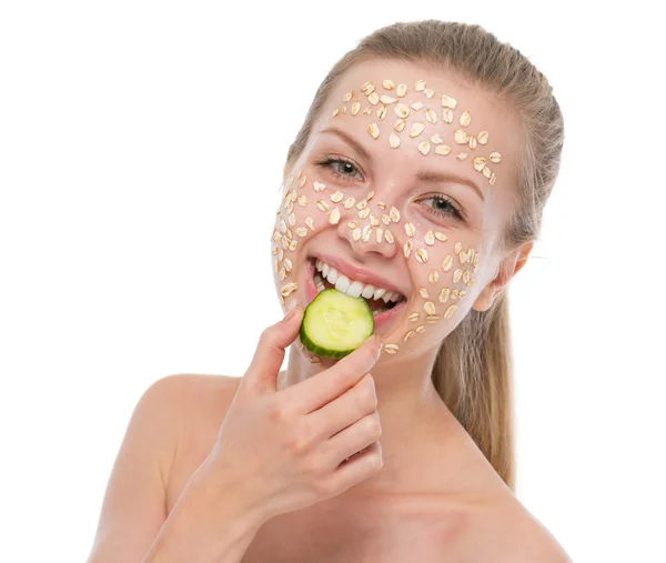 Happy young woman with making oatmeal mask with cucumber — Stock Photo, Image