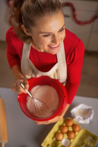 Heureuse jeune femme au foyer fouettant la pâte — Photo