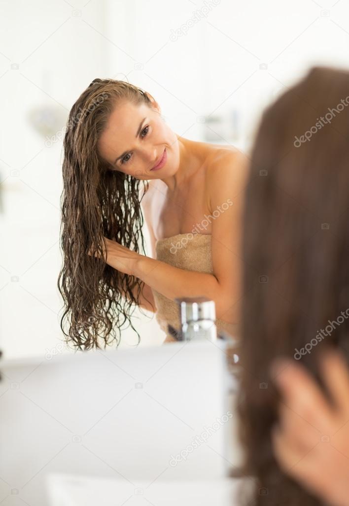 Young woman with long wet hair in bathroom