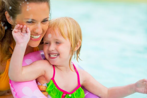 Retrato de madre feliz y niña nadando en la piscina —  Fotos de Stock