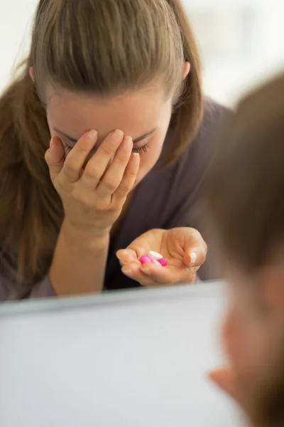 Retrato de mujer joven estresada con pastillas en el baño — Foto de Stock