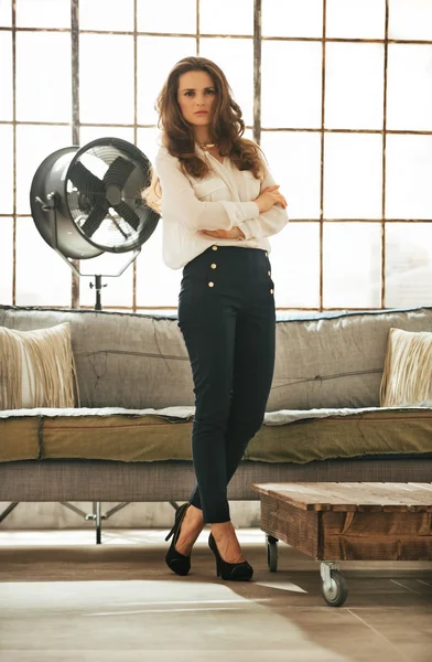 Full length portrait of young woman in loft apartment — Stock Photo, Image