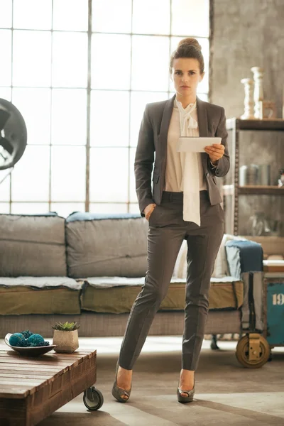 Full length portrait of thoughtful business woman using tablet p — Stock Photo, Image