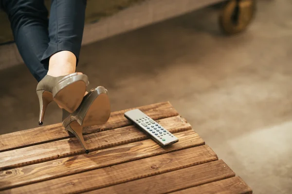 Close up on woman watching tv in loft apartment — стоковое фото