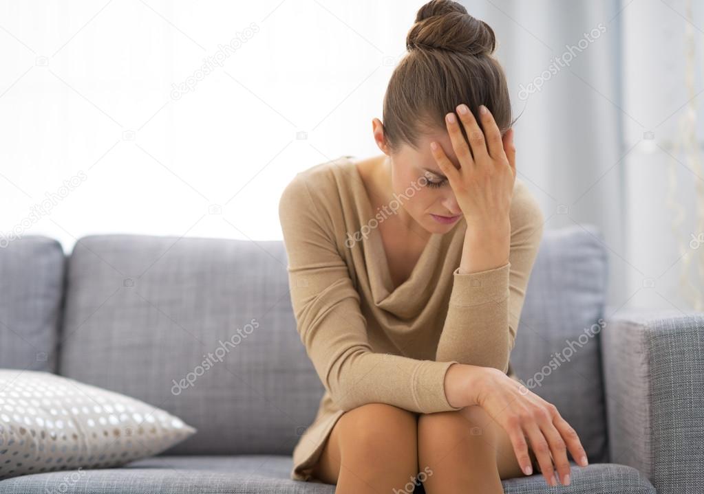 Stressed young housewife in living room