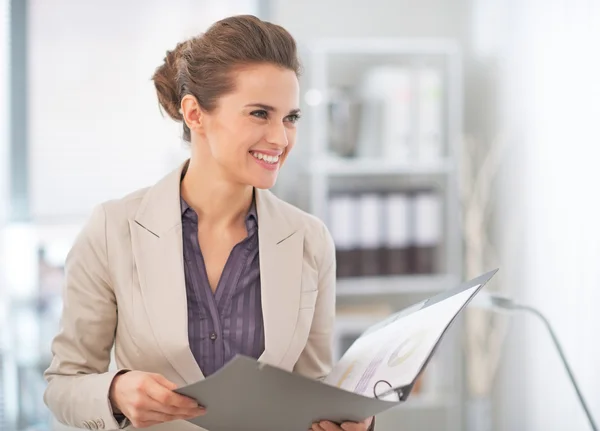 Happy business woman with documents in office — Stock Photo, Image