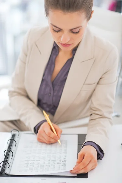 Portrait of business woman writing in document Royalty Free Stock Images