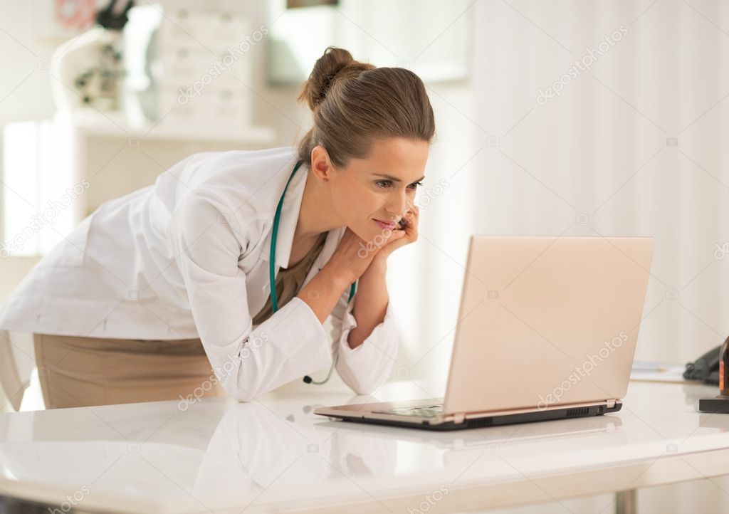 Doctor woman using laptop in office