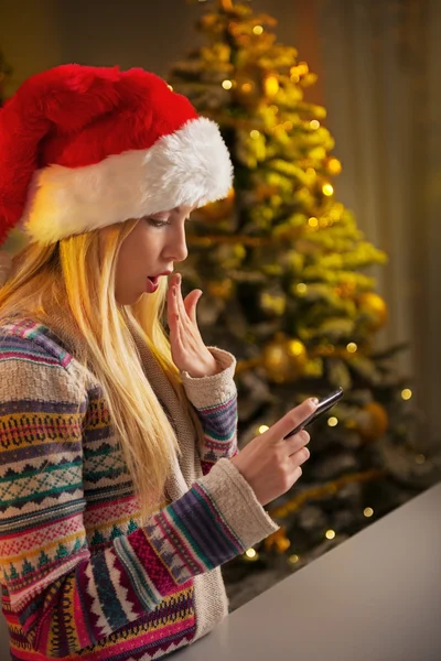 Profile portrait of surprised teenager girl in santa hat writing — Stock Photo, Image