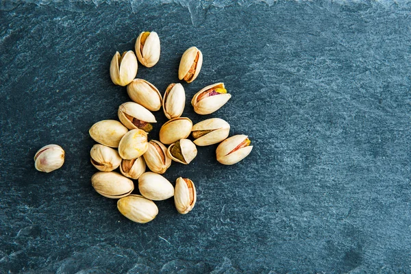 Closeup on pistachio on stone substrate — Stock Photo, Image