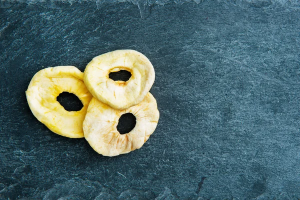 Closeup on dried apple slices on stone substrate — Stock Photo, Image