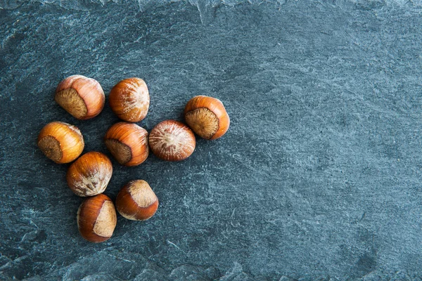 Closeup on hazelnuts on stone substrate — Stock Photo, Image