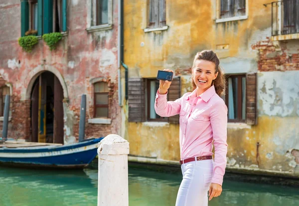 Happy young woman showing photo camera while in venice, italy — Stock Photo, Image