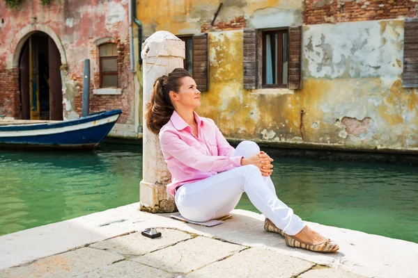 Jonge vrouw zittend op straat in Venetië, Italië — Stockfoto