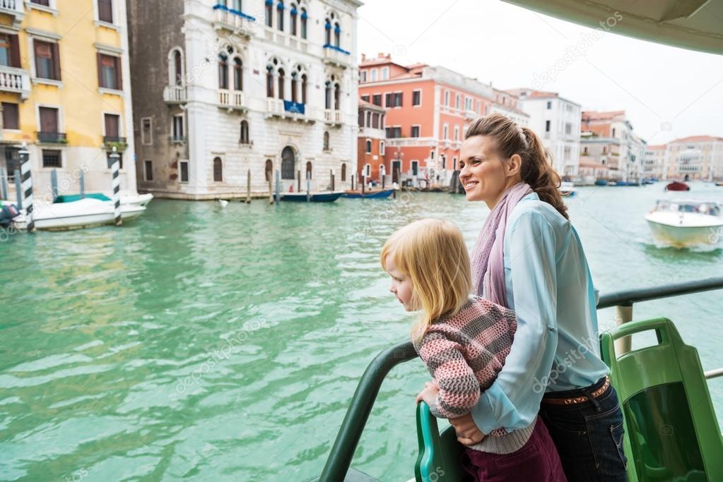 Mother and baby girl travel by venice water bus