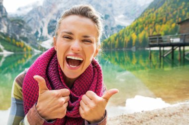 Portrait of happy young woman on lake braies in south tyrol, ita clipart