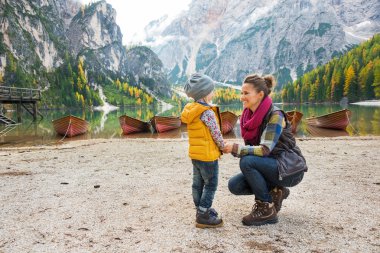 Mother and baby on lake braies in south tyrol, italy clipart