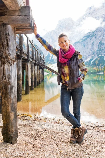 Full length portrait of happy young woman on lake braies in sout — Stock Photo, Image