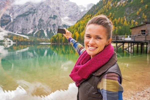 Glad ung kvinna ta foto på sjön braies i södra tyrol, det — Stockfoto