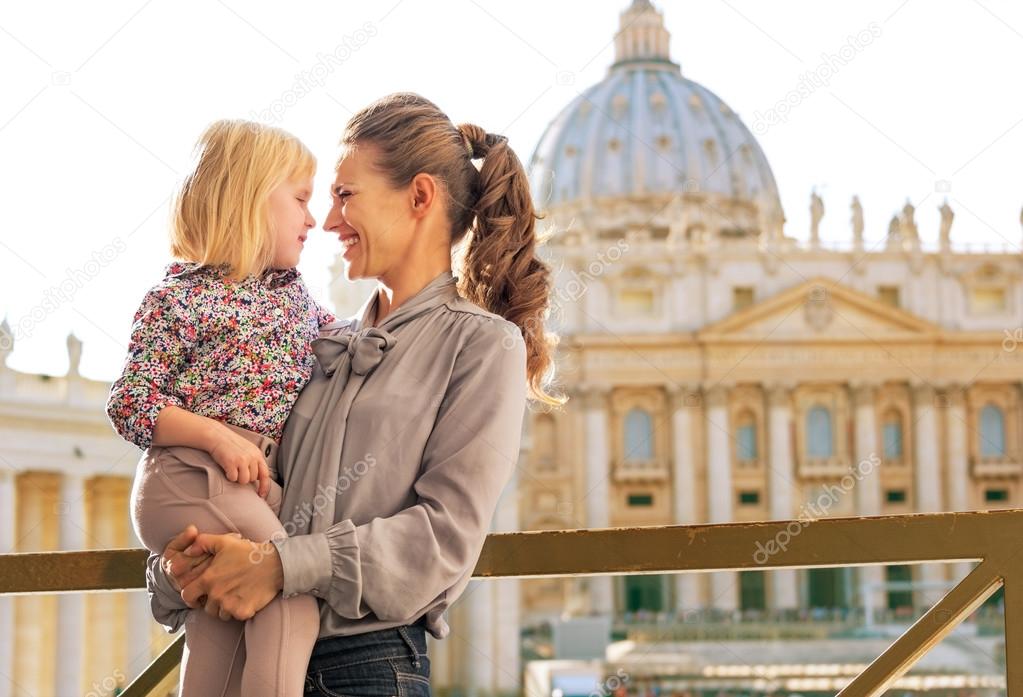 Portrait of happy mother and baby girl on piazza san pietro in v