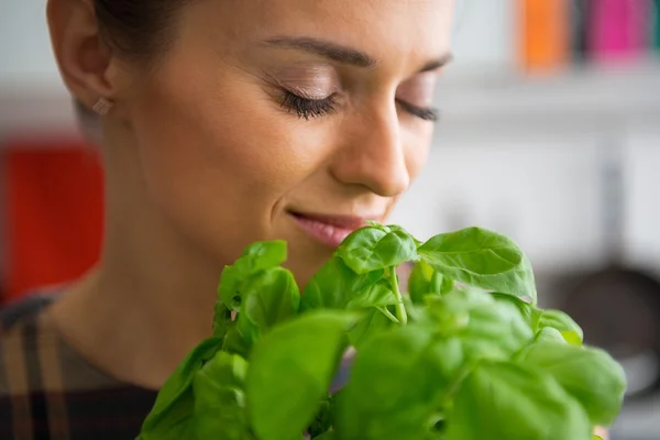 Young housewife enjoying fresh basil — Stock Photo, Image