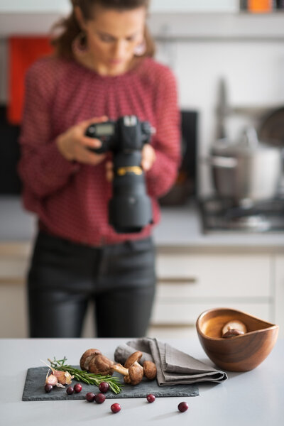 Closeup on mushrooms lingonberries and rosmarinus on table and f